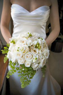 Bridal boquet of white roses with green accents